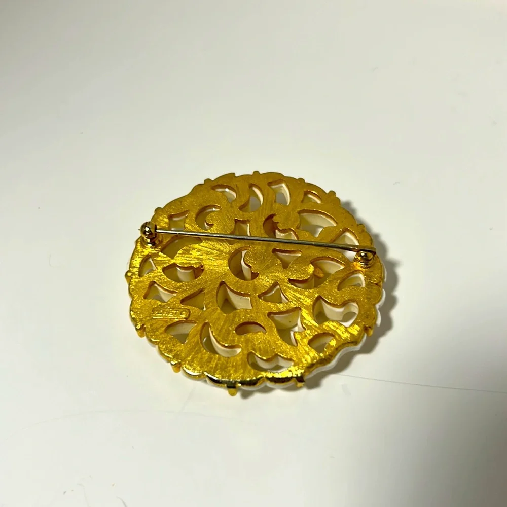 Monet brooch vintage filigree gold tone white cut out design 2 “